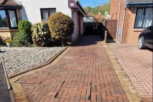 The same driveway after pressure washing, the blocks back to their original red and buff colour