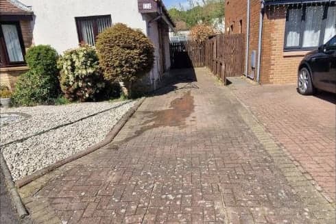 A Falkirk block paved driveway before cleaning, dull and grey with dirt and staining across the blocks